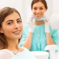 Patient smiling with braces in a dental office, showing braces progress month by month